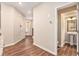 Hallway featuring wood-look flooring, access to the front door, and a view of the half-bath with pedestal sink at 305 Duval Dr, Alpharetta, GA 30009