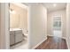 Hallway leading to the bathroom and bedroom; features wood-look flooring and modern paint at 305 Duval Dr, Alpharetta, GA 30009