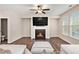 Comfortable living room featuring a fireplace, ceiling fan, and hardwood floors at 305 Duval Dr, Alpharetta, GA 30009