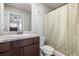 The bathroom features a granite countertop with dark cabinets, a toilet, and a shower at 400 Toronto Cir, Hampton, GA 30228