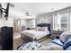 Spacious bedroom with large bed, ceiling fan and sitting area bathed in natural light at 400 Toronto Cir, Hampton, GA 30228