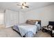 This bedroom includes carpet, ceiling fan and a queen bed with a dark wood frame at 400 Toronto Cir, Hampton, GA 30228