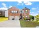 Attractive two-story brick home with a two-car garage and a well-manicured lawn at 400 Toronto Cir, Hampton, GA 30228