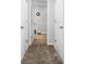 Bright hallway leading to a room with wood flooring and white doors at 400 Toronto Cir, Hampton, GA 30228