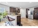 Stylish kitchen featuring a breakfast bar with seating, stainless steel refrigerator, and sleek cabinetry at 400 Toronto Cir, Hampton, GA 30228