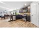 Open kitchen with stainless steel appliances, dark cabinetry, granite countertops, and a view to the dining area at 400 Toronto Cir, Hampton, GA 30228