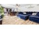 Spacious living area with an open floor plan, connecting the kitchen, dining, and living spaces, featuring a comfy blue sofa at 400 Toronto Cir, Hampton, GA 30228