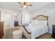 A cozy main bedroom with neutral walls, carpet, and ceiling fan with a queen size bed at 400 Toronto Cir, Hampton, GA 30228