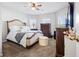 A cozy main bedroom with neutral walls, carpet, and ceiling fan with a queen size bed at 400 Toronto Cir, Hampton, GA 30228