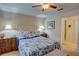 Relaxing bedroom with soft lighting features a tufted headboard and convenient access to the en suite bathroom at 500 Bainbridge Dr, Atlanta, GA 30327