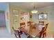 Dining area featuring a wooden table with seating for six, classic decor, and pass-through to the kitchen at 500 Bainbridge Dr, Atlanta, GA 30327