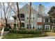 Two-story condo with a green exterior, a screened porch, and attractive landscaping at 500 Bainbridge Dr, Atlanta, GA 30327