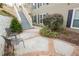 Serene patio space featuring two metal chairs, lush landscaping, and direct access to staircase at 500 Bainbridge Dr, Atlanta, GA 30327