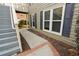 Exterior path leading to a unit, complemented by windows with black shutters at 500 Bainbridge Dr, Atlanta, GA 30327