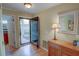 Inviting foyer with hardwood floors, decorative mirror, and an open view to the outside at 500 Bainbridge Dr, Atlanta, GA 30327