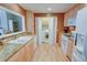 Functional kitchen offers granite counters, wood cabinets, and a handy washer and dryer concealed behind folding doors at 500 Bainbridge Dr, Atlanta, GA 30327