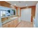 Well-lit kitchen features light wood cabinets, granite countertops, and a pass-through to the living room at 500 Bainbridge Dr, Atlanta, GA 30327