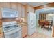 This kitchen features wood cabinets and a refrigerator, flowing into a dining area for convenient meals at 500 Bainbridge Dr, Atlanta, GA 30327