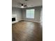 Inviting living room with new flooring, fireplace, and natural light at 9866 Point View Dr, Jonesboro, GA 30238