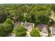 Aerial view of a home nestled among lush green trees in a serene neighborhood at 4481 Mccart Cv, Stone Mountain, GA 30083