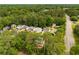 Wide aerial view of a neighborhood surrounded by mature green trees at 4481 Mccart Cv, Stone Mountain, GA 30083