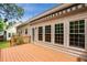 Backyard wooden deck with awning surrounded by lush greenery offering privacy and shade at 4481 Mccart Cv, Stone Mountain, GA 30083