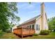 Home featuring a wooden deck, chimney, with a lawn, and mature trees at 4481 Mccart Cv, Stone Mountain, GA 30083