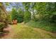 View of the backyard, showing vegetation and wooden deck at 4481 Mccart Cv, Stone Mountain, GA 30083