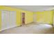 Bright bedroom featuring yellow walls and carpeted floors at 4481 Mccart Cv, Stone Mountain, GA 30083