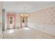 Dining room with chandelier, traditional floral wallpaper and large windows at 4481 Mccart Cv, Stone Mountain, GA 30083