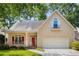 A charming home with a front porch, red shutters, and a two-car garage at 4481 Mccart Cv, Stone Mountain, GA 30083
