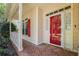 Close-up of the front entrance featuring a red front door, red shutters, and brick walkway at 4481 Mccart Cv, Stone Mountain, GA 30083