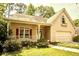 Charming single-Gathering home with a welcoming front porch and well-manicured lawn and attached two car garage at 4481 Mccart Cv, Stone Mountain, GA 30083