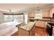 Bright kitchen features granite countertops, hardwood floors, stainless appliances and an adjacent sunroom at 4481 Mccart Cv, Stone Mountain, GA 30083