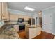 Charming kitchen featuring granite countertops, stainless steel appliances, hardwood floors at 4481 Mccart Cv, Stone Mountain, GA 30083
