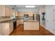 Charming kitchen featuring granite countertops, stainless steel appliances, and hardwood floors at 4481 Mccart Cv, Stone Mountain, GA 30083