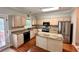 Beautiful kitchen with granite counters, an island, hardwood floors and stainless steel appliances at 4481 Mccart Cv, Stone Mountain, GA 30083