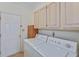 Laundry room with appliances and overhead storage at 4481 Mccart Cv, Stone Mountain, GA 30083