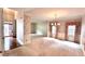 Spacious formal living and dining area featuring elegant lighting, wallpaper accents, and large sunny windows at 4481 Mccart Cv, Stone Mountain, GA 30083
