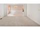 Large living area with light carpeting and a doorway to the next room at 4481 Mccart Cv, Stone Mountain, GA 30083