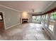 Sunlit living room featuring a cozy fireplace, large windows and high ceilings at 4481 Mccart Cv, Stone Mountain, GA 30083