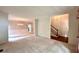 Open-concept living room featuring elegant chandelier lighting, wainscoting and easy access to the staircase and main floor at 4481 Mccart Cv, Stone Mountain, GA 30083