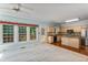 Spacious living room with large windows, hardwood floors, and direct view of the kitchen at 4481 Mccart Cv, Stone Mountain, GA 30083