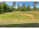 Spacious backyard featuring a large grassy area, partial fence line and wooded views at 47 Whitley Ct, Dallas, GA 30157
