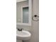 Bathroom with a white pedestal sink, modern faucet, and white framed mirror at 47 Whitley Ct, Dallas, GA 30157