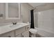 A bathroom with a white vanity, toilet, and shower with a dark shower curtain at 47 Whitley Ct, Dallas, GA 30157