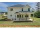 The back exterior of the home featuring a covered patio and large grassy yard at 47 Whitley Ct, Dallas, GA 30157