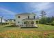 The back exterior of the home featuring a covered patio and large grassy yard at 47 Whitley Ct, Dallas, GA 30157