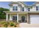 Inviting front entrance with stone accents, a two-car garage, and a well-manicured lawn at 47 Whitley Ct, Dallas, GA 30157