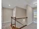 Carpeted hallway featuring a wooden staircase with wrought iron spindles at 47 Whitley Ct, Dallas, GA 30157